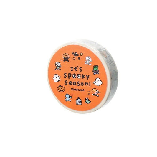 Round container with Halloween-themed design and text on an orange background