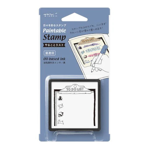 Paintable stamp set with a black stamp and white packaging on a light blue background