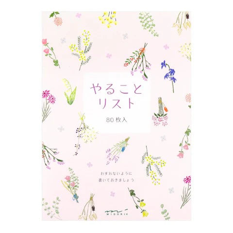 Notebook with floral design and text on a light pink background