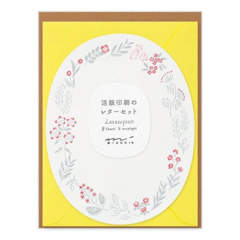 Letterpress set with floral design on a yellow background