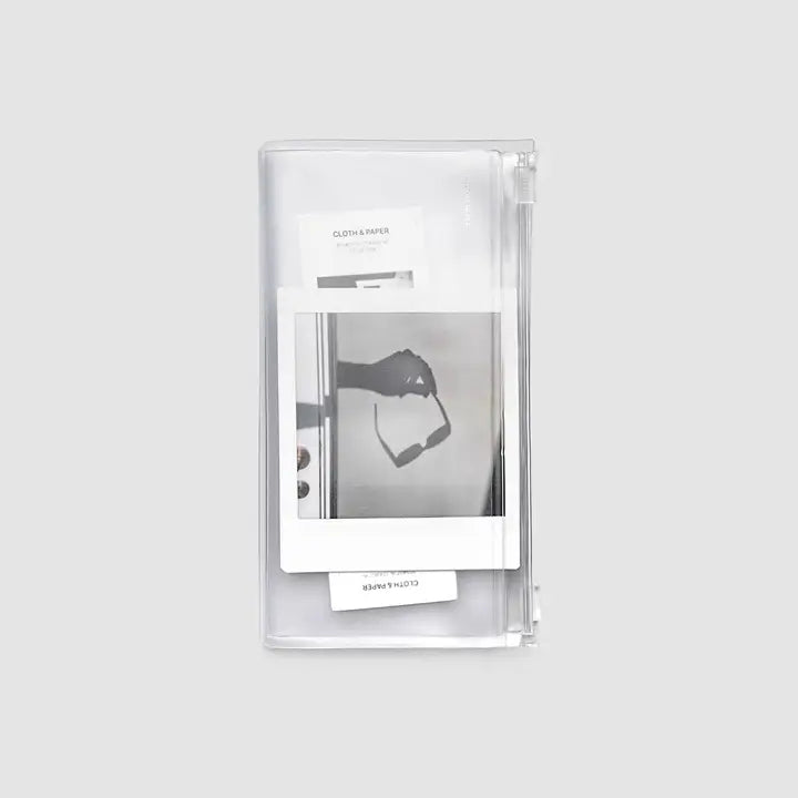Clear plastic packaging with a black and white product image on a light gray background