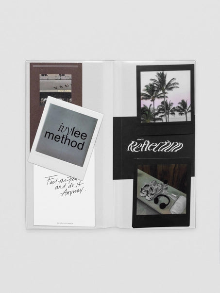 Open book with photo prints and text on a white background