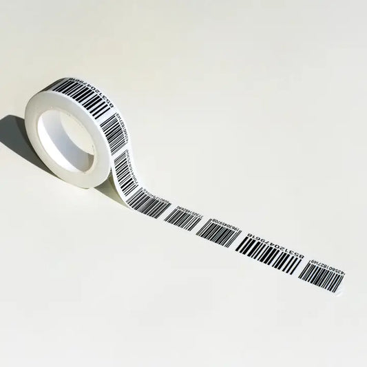 A roll of white tape printed with repeating black barcode patterns, shown on a clean off-white background with a cast shadow.