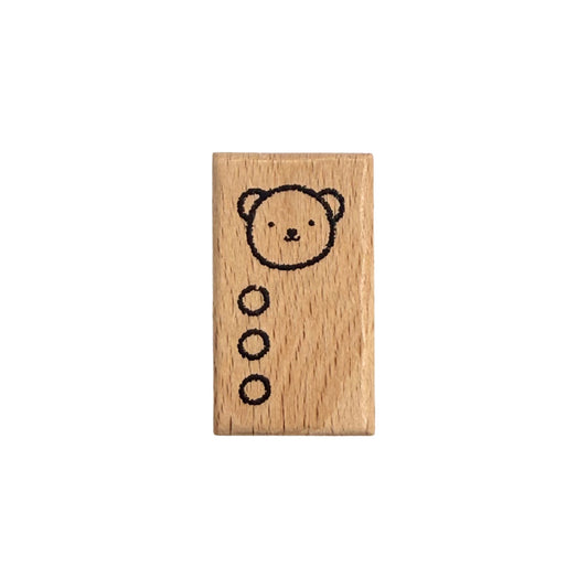 Wooden stamp with a bear design on a white background