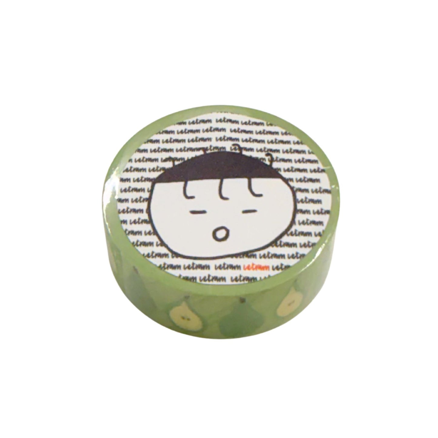Round green washi with a cartoon face and text on a white background