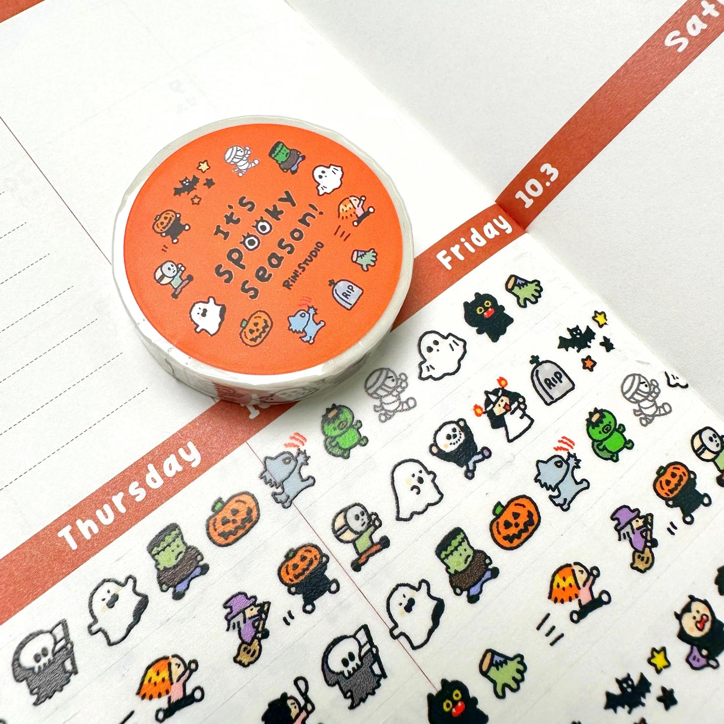 Halloween-themed washi tape with stickers on a planner page