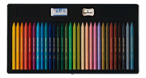 Set of colored pencils in a black case with a sharpener on a white background