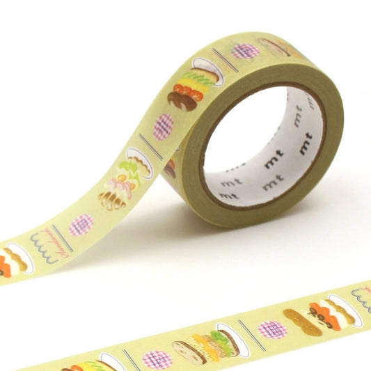 Roll of decorative tape with food-themed designs on a white background