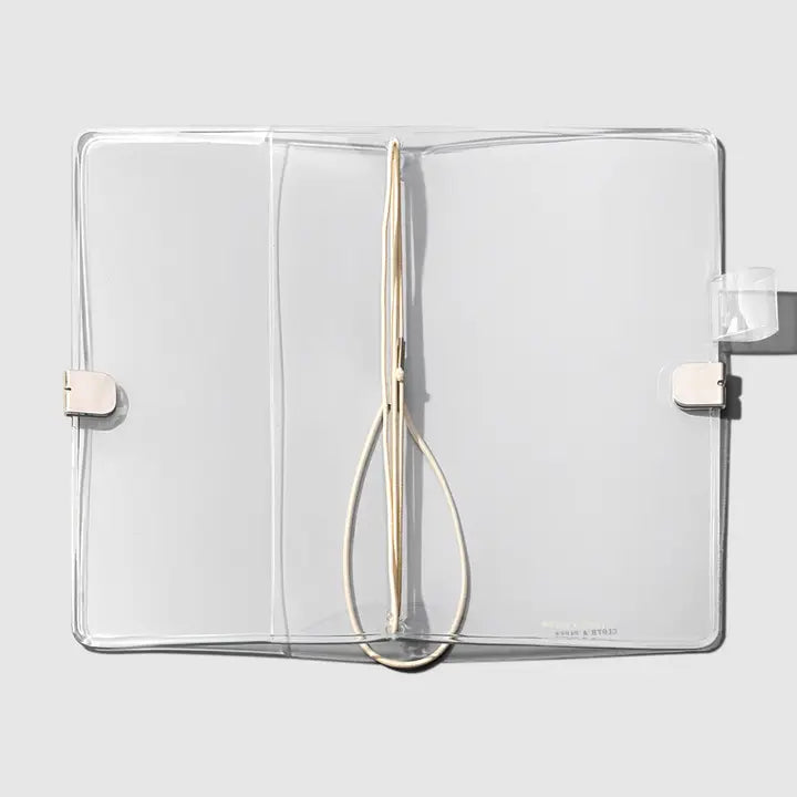 Clear plastic case with a wooden tool inside on a light gray background
