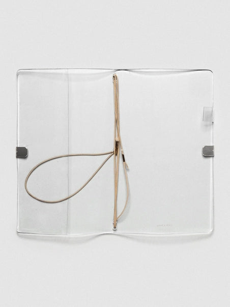 Clear plastic cover with a strap on a white background