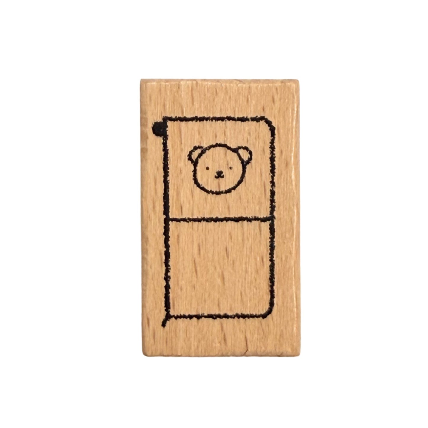 Wooden stamp with a bear design on a white background