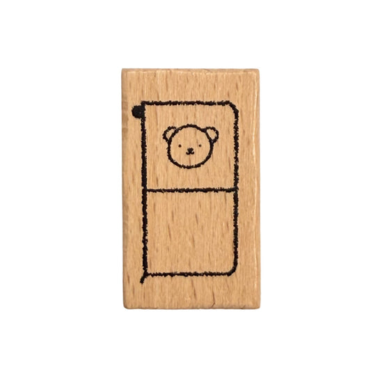 Wooden stamp with a bear design on a white background