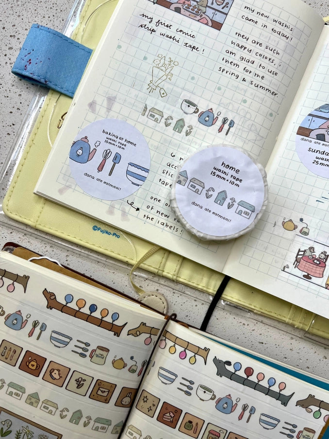 Notebook with stickers and a pen on a textured surface