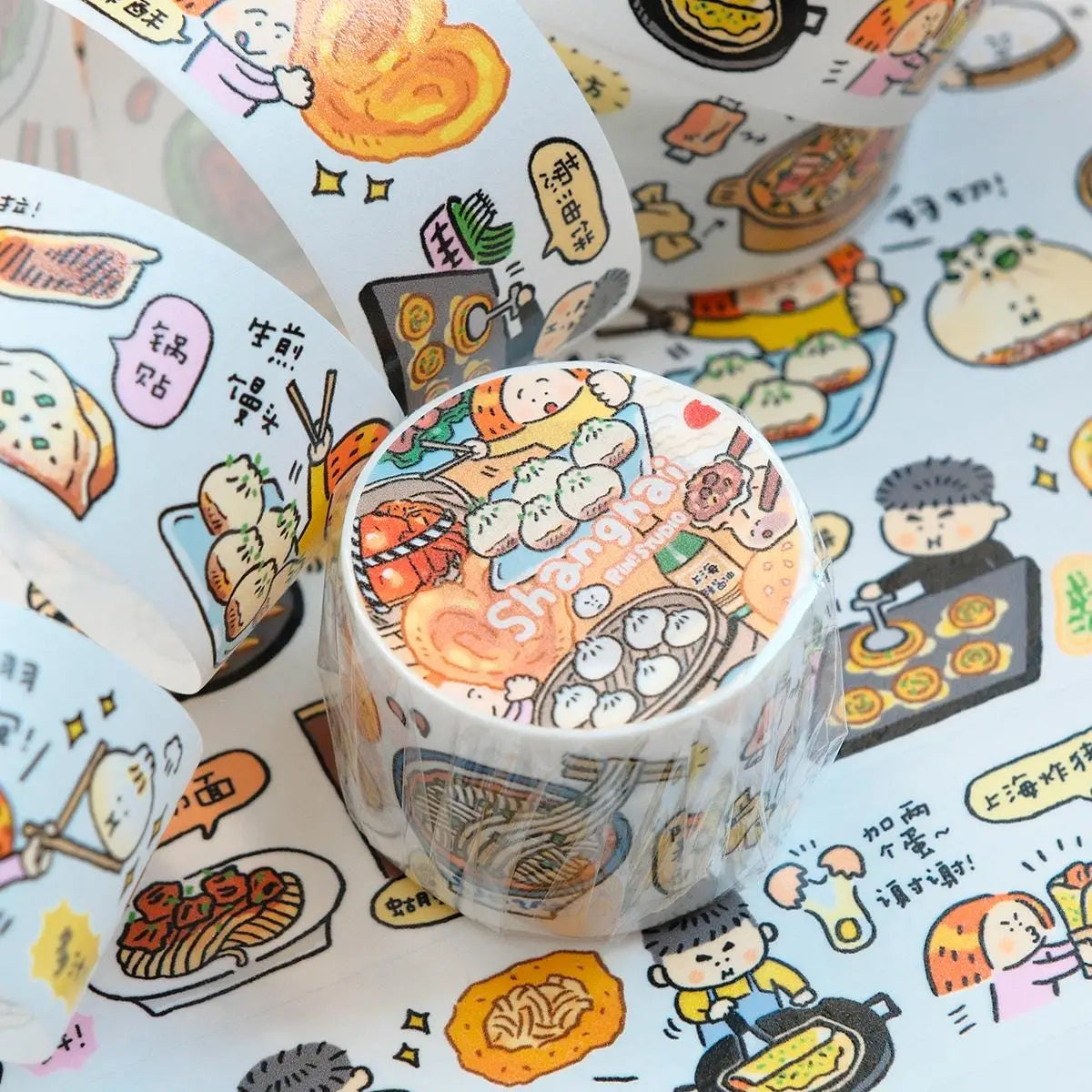 Rolls of decorative tape with cartoon food illustrations on a matching background