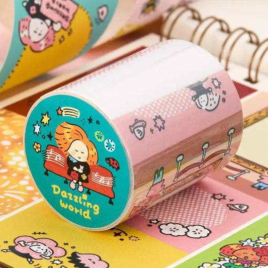 A roll of decorative washi tape with a whimsical cartoon illustration, shown partially unrolled on top of other colorful patterned paper rolls. The main tape features a pink pattern with small illustrated characters and stars, and the circular end is decorated with a teal background, a cartoon girl, and the text 'Dazzling world'.