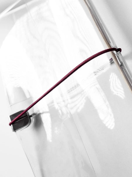 Close-up of a white umbrella with a red handle on a white background