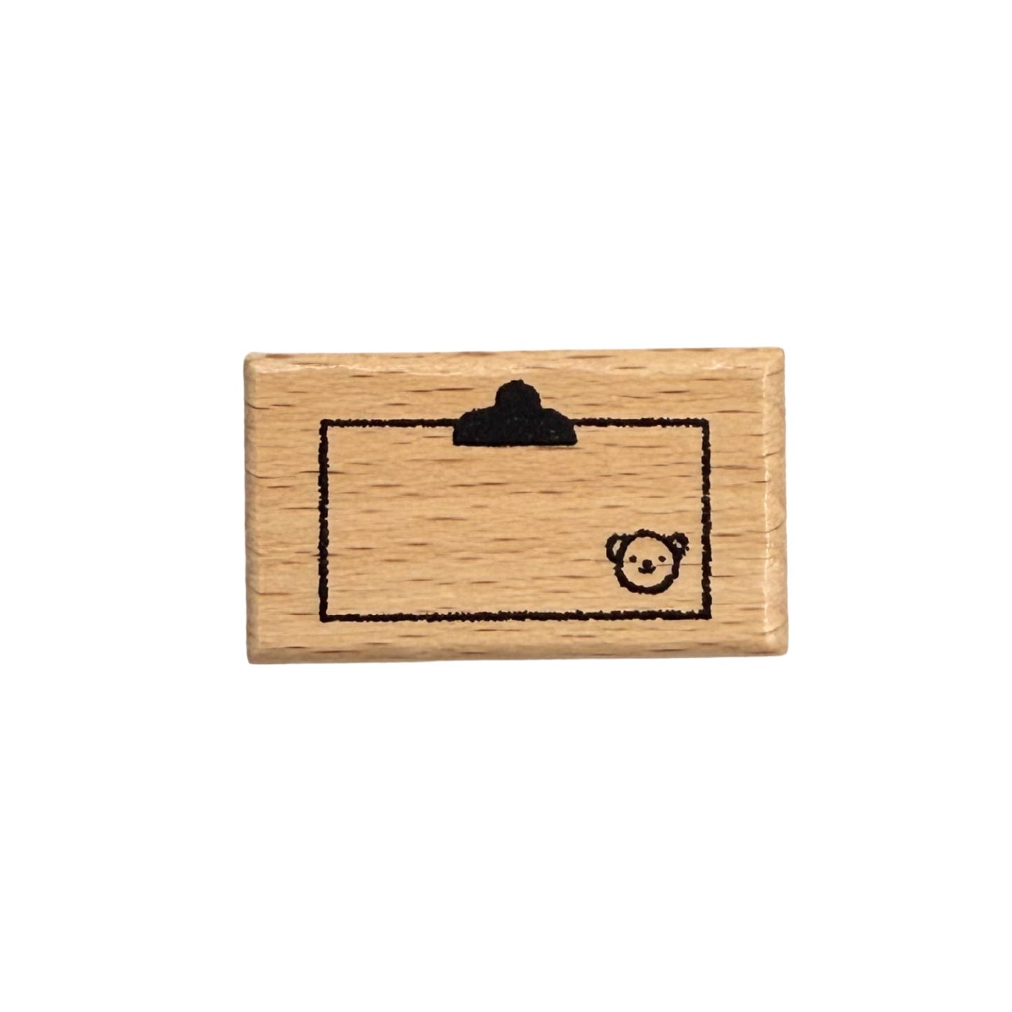 Wooden stamp with a bear design on a white background