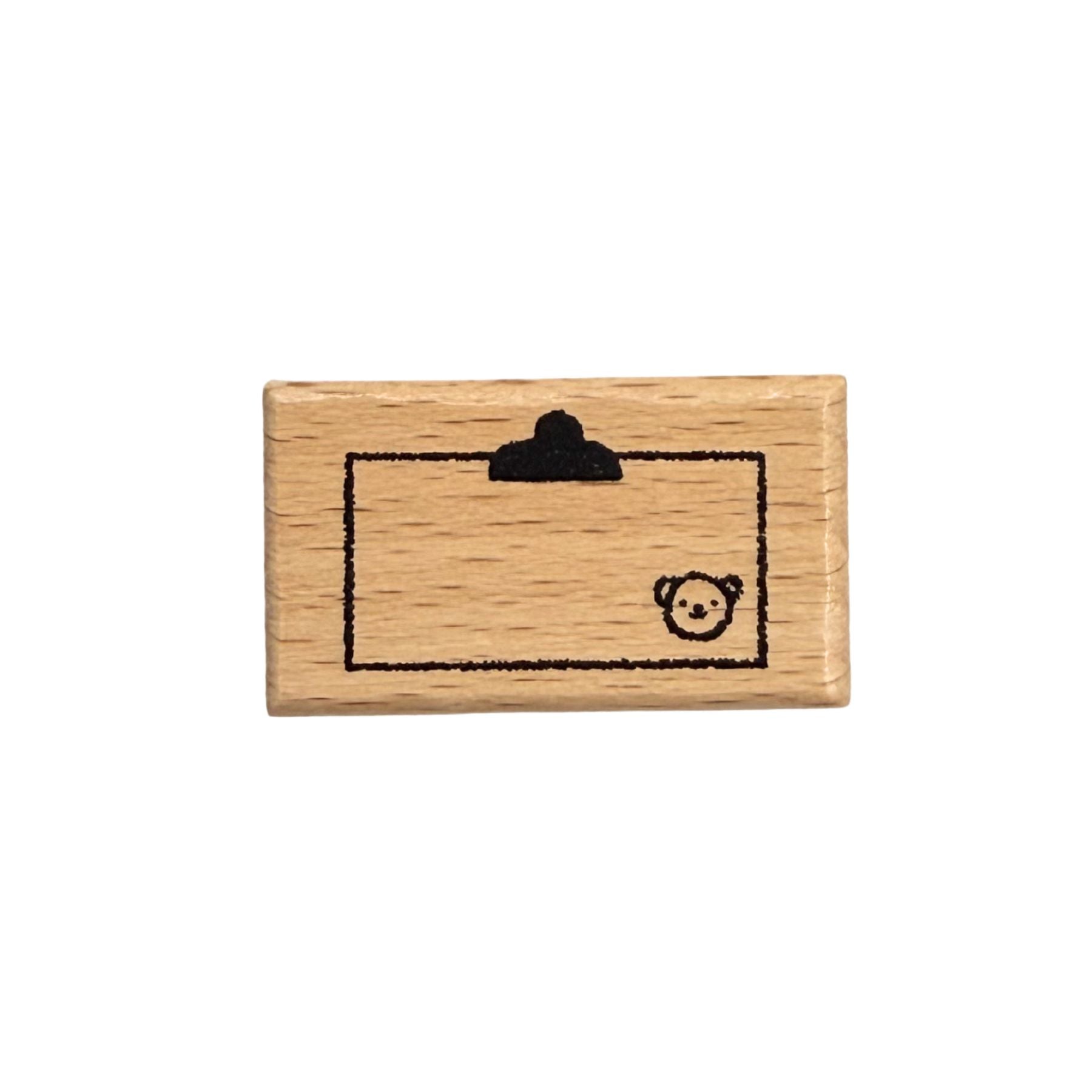 Wooden stamp with a bear design on a white background