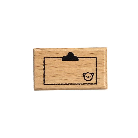 Wooden stamp with a bear design on a white background