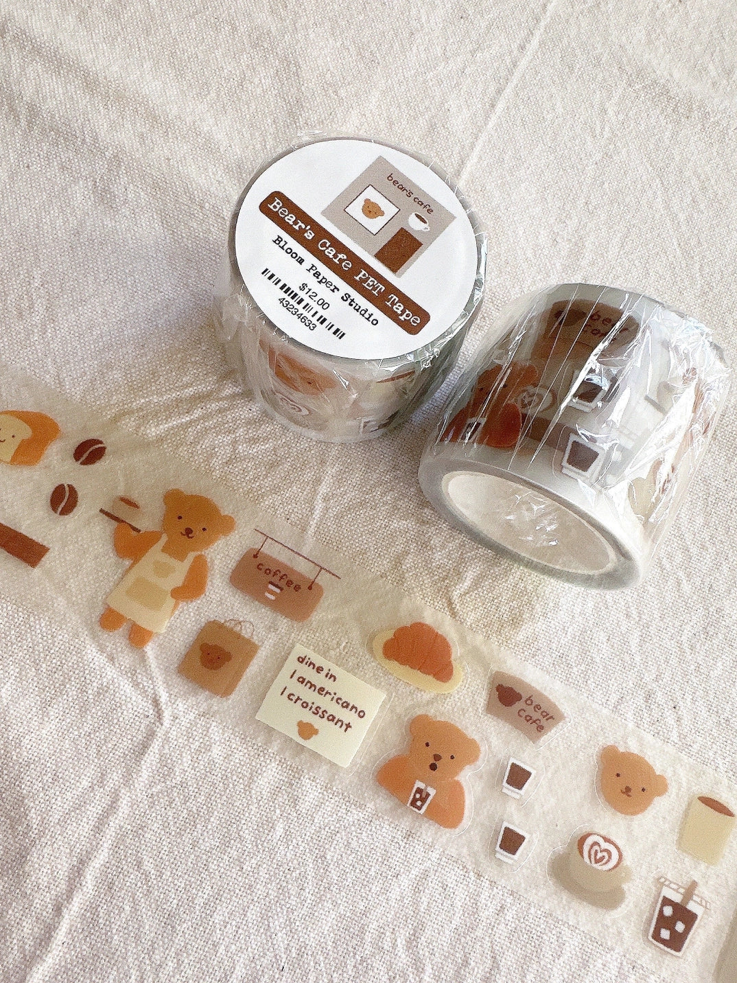 Clear washi tape with cute designs on a textured surface