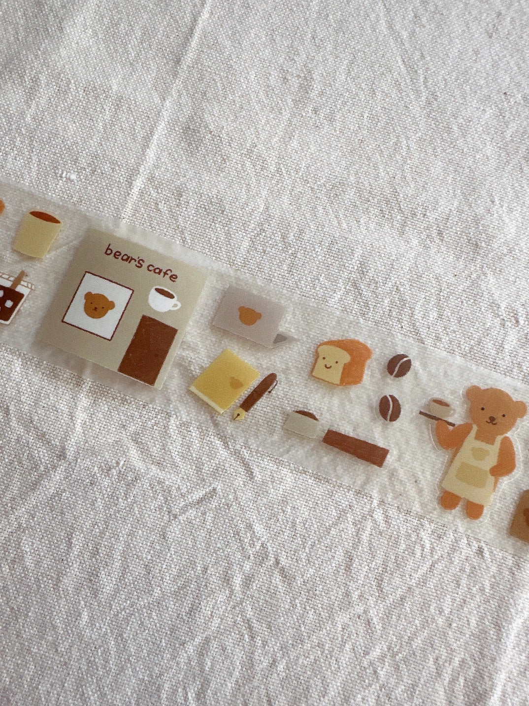 Set of cute bear-themed stickers on a textured white surface