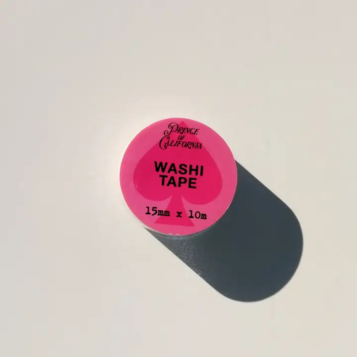 Pink washi tape roll with black text on a light gray background