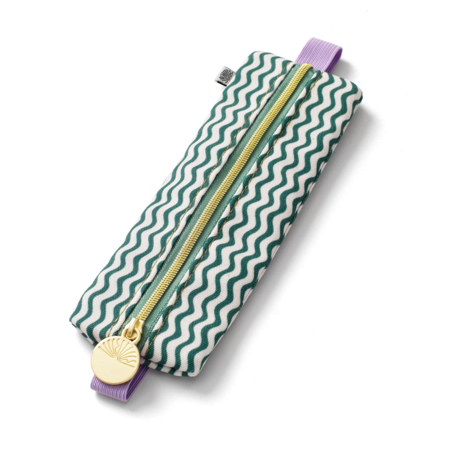 Pencil case with green wavy pattern and gold zipper on a white background