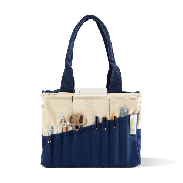 Navy and beige tote bag with various tools and items on a white background