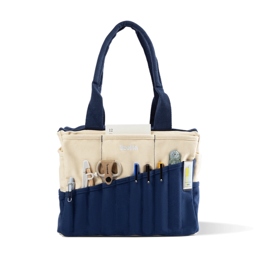 Navy and beige tote bag with various tools and items on a white background