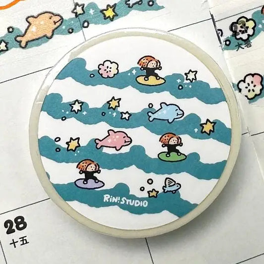 Circular design with cartoon characters and sea elements on a white background, featuring the brand 'Rini Studio'.