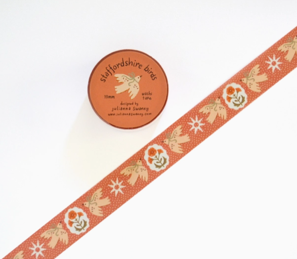 Decorative ribbon with bird pattern and a circular label on a white background