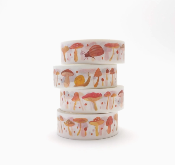 Stack of washi tape with mushroom and snail designs on a white background