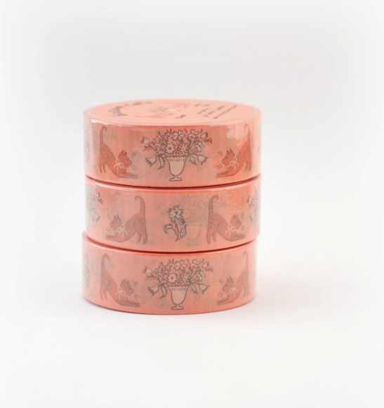Three pink washi tape rolls with decorative designs on a white background