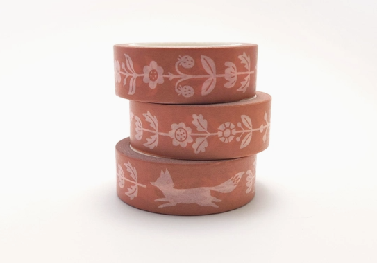 Three terracotta pots with white floral and animal designs on a white background