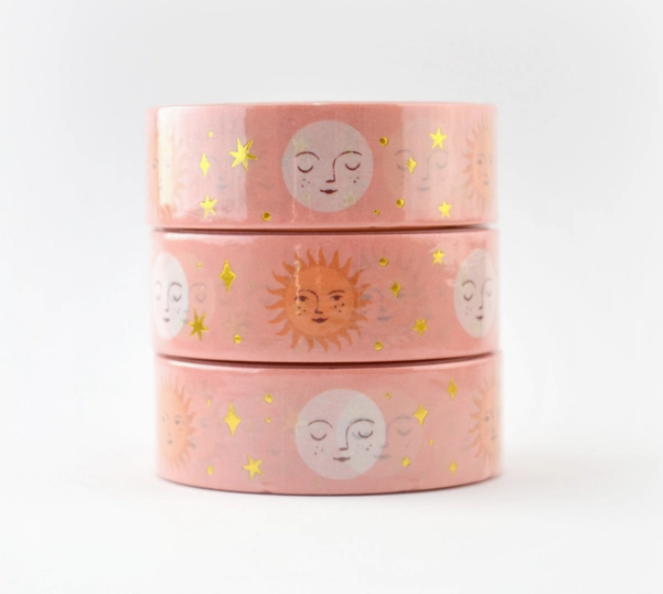 Three pink washi tapes with sun and moon designs on a white background