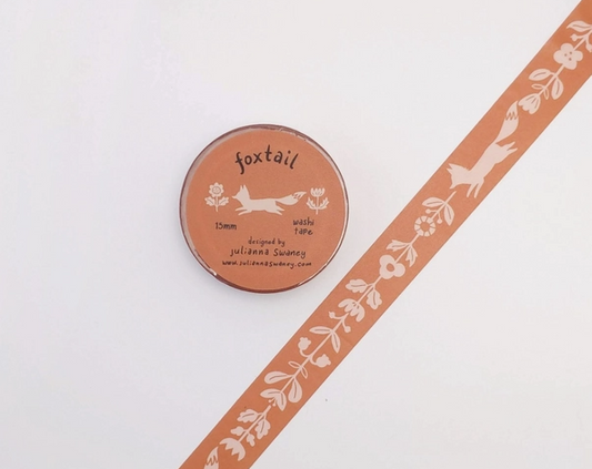 Round container labeled 'foxtail' with decorative ribbon on a white background