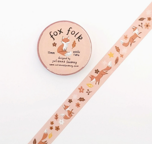 Washi tape with fox and leaf designs next to a container labeled 'fox folk' on a white background