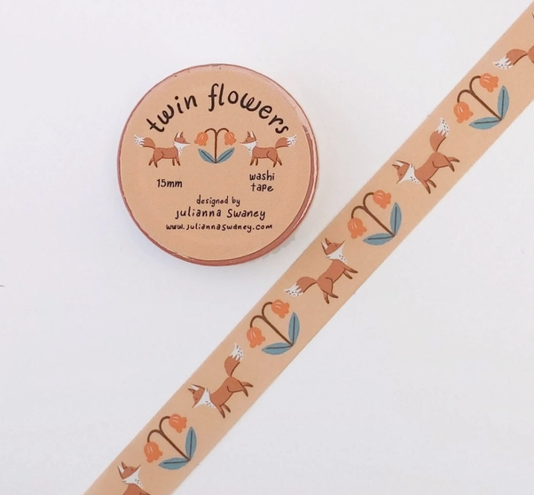 Washi tape with fox and flower design next to a round container labeled 'twin flowers'.