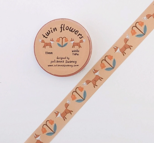Washi tape with fox and flower design next to a round container labeled 'twin flowers'.