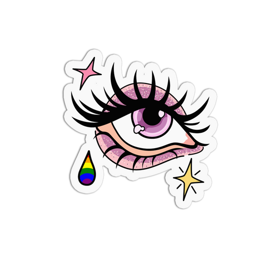 A die-cut sticker featuring a stylized cartoon eye with long black eyelashes, a pink glittery iris, a pink teardrop with rainbow stripes, and two small star accents on a white background.