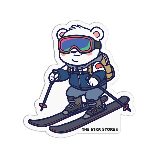 Cartoon bear skiing with goggles and ski equipment, branded 'The Stkr Store'.