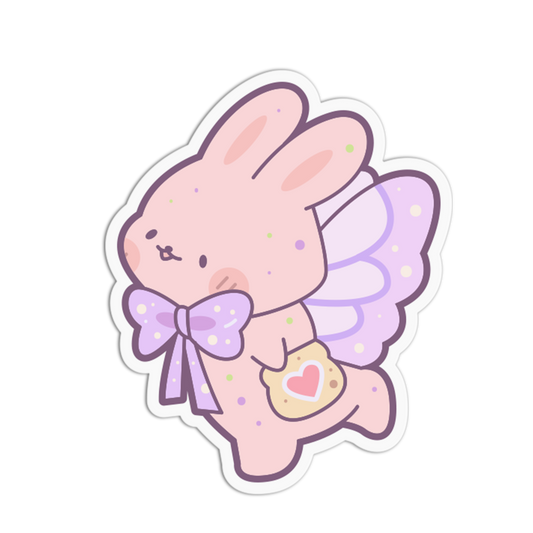 A die-cut sticker featuring a cute pastel pink bunny angel character with purple wings, a purple polka-dot bow, and a small heart-shaped cookie, shown on a plain white background.