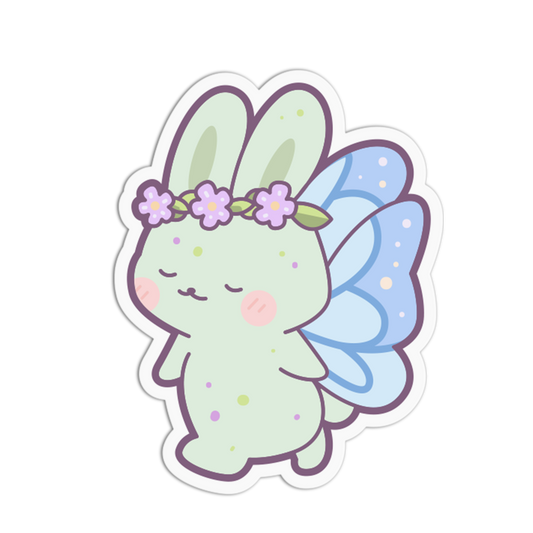 A die-cut sticker featuring a cute pastel bunny fairy with light green skin, lavender-purple flower crown, and light blue wings, shown on a plain white background.