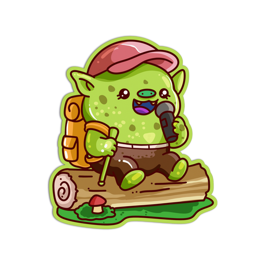 A cartoon-style die-cut sticker of a green goblin character wearing a pink cap and brown pants, sitting on a log with a backpack, walking stick, and holding a microphone, on a plain white background.