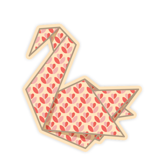 Two folded paper swans with pink heart pattern on a white background