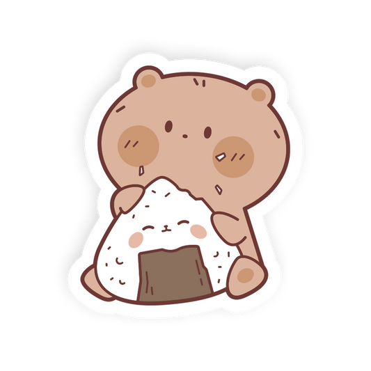 A cute cartoon sticker of a brown bear holding a white onigiri with a dark brown seaweed sheet, shown on a plain white background.