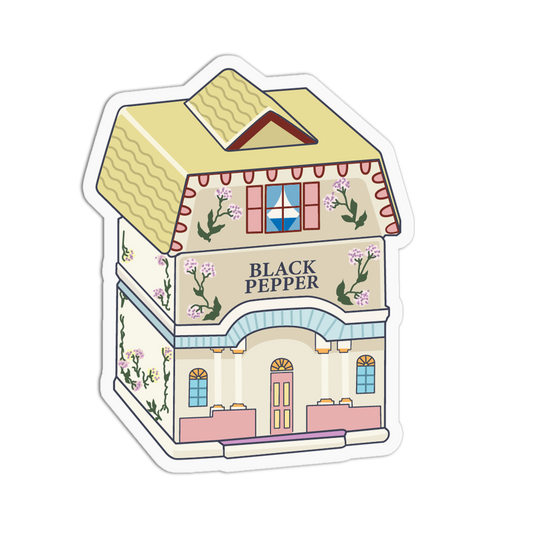 A die-cut sticker featuring a whimsical illustration of a Black Pepper brand house, styled like a vintage perfume bottle with a pitched roof, floral details, and pastel accents.