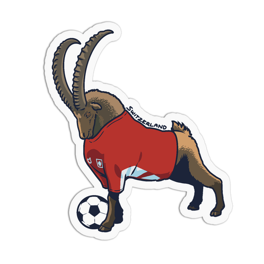 A die-cut sticker featuring a stylized brown goat wearing a red soccer jersey with 'SWITZERLAND' text and a small crest, standing beside a black-and-white soccer ball on a white background.