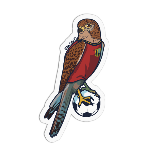 A die-cut sticker featuring a stylized bird of prey wearing a red Belgium soccer jersey and standing on a black-and-white soccer ball, shown on a plain white background.