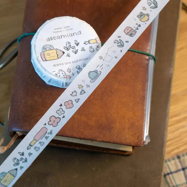 Decorative tape with cartoon designs on a brown notebook